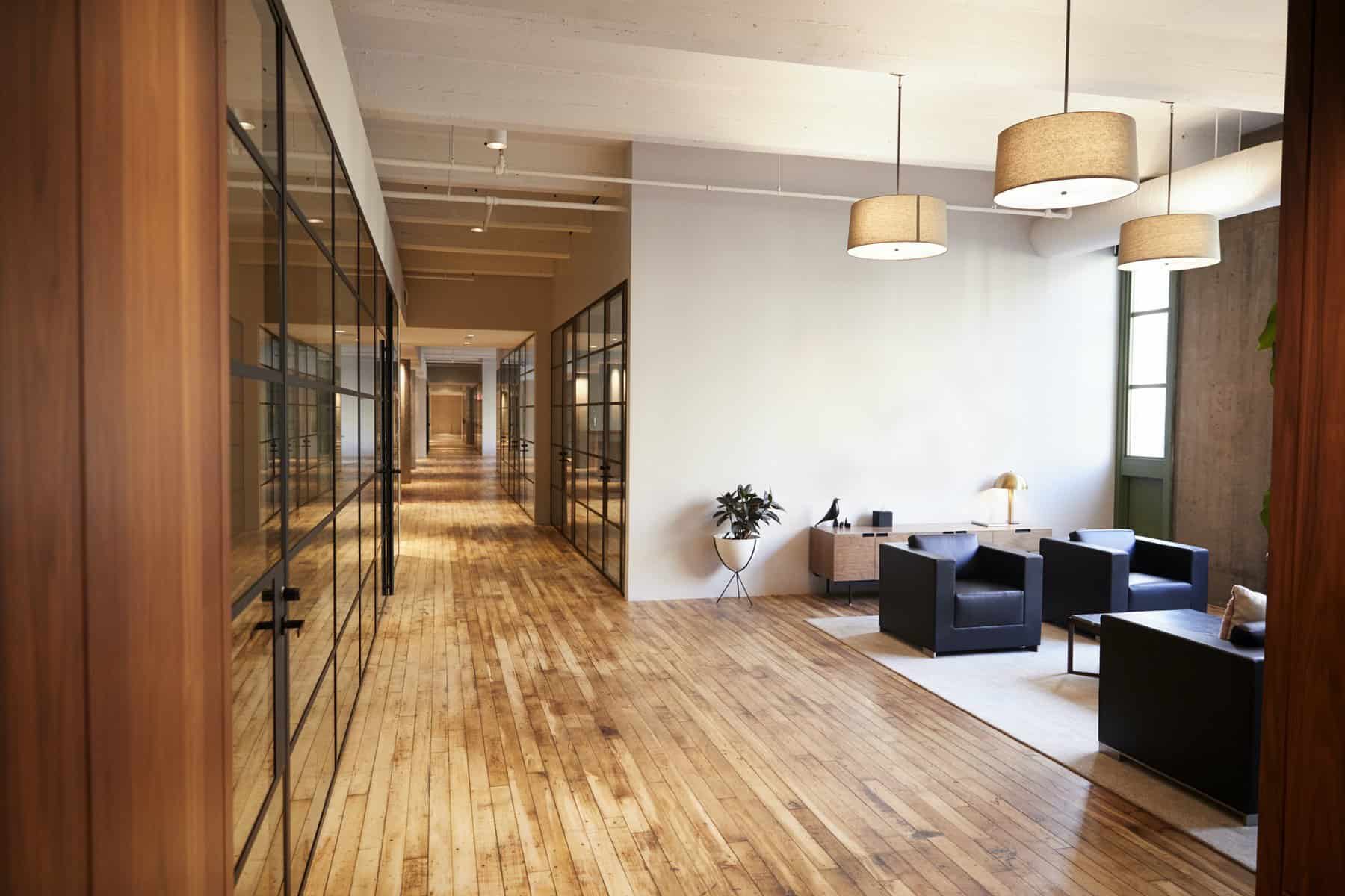 Commercial interior painting Cincinnati - modern office hallway with glass walls and professional finish