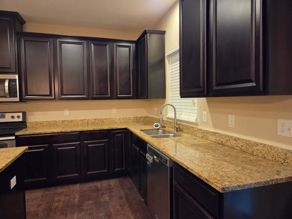 Cabinet painting services Cincinnati - dark brown kitchen cabinets with granite counters and professional finish