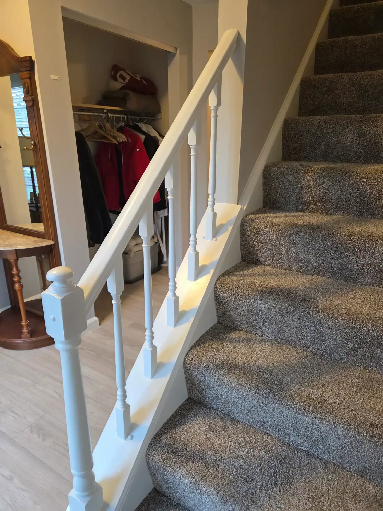 House painting contractors Northern Cincinnati - white staircase with gray carpet and under-stair storage