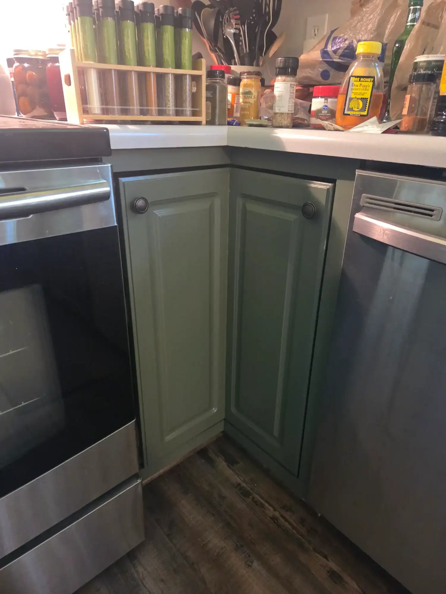 Professional cabinet painting Mason - sage green kitchen cabinets with white counters and modern hardware