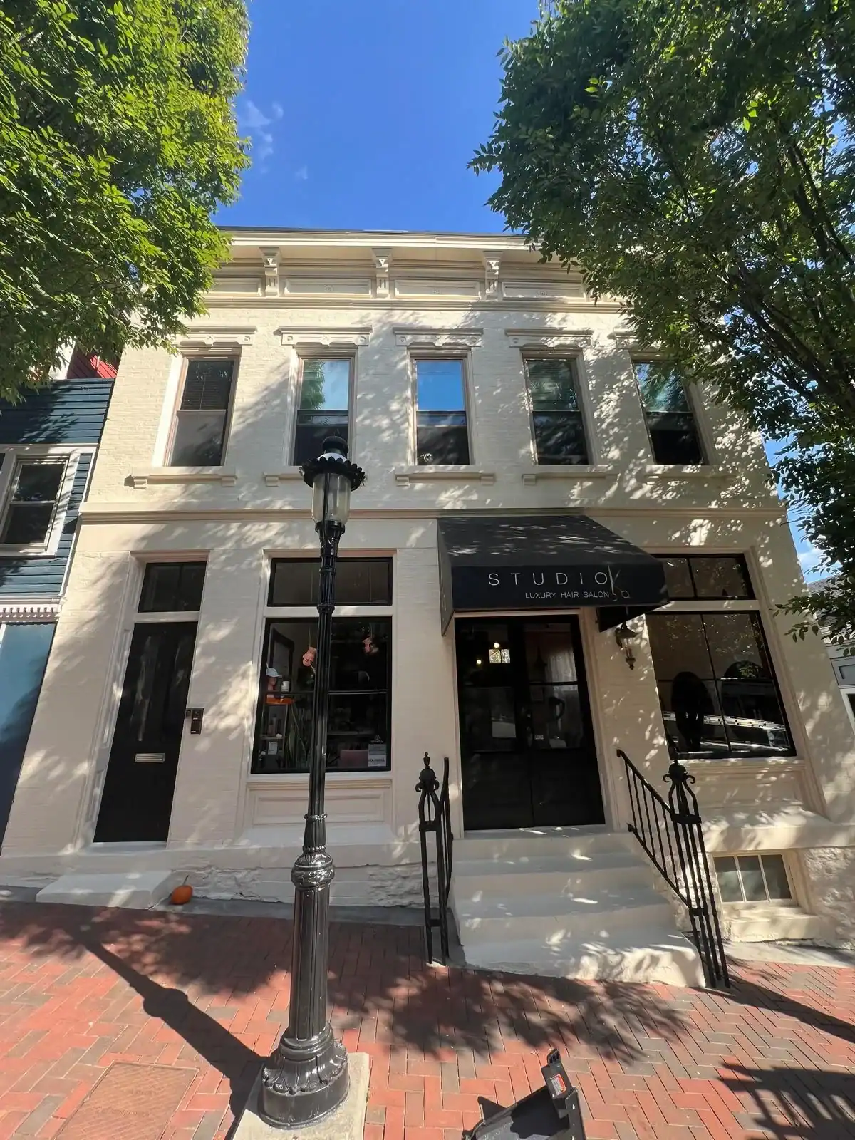 Commercial painting Hamilton Ohio - restored historic building with white facade and black awnings